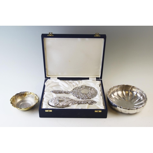 132 - A cased silver dressing table set, Birmingham circa 1983, comprising hand mirror and hair brush, eac... 