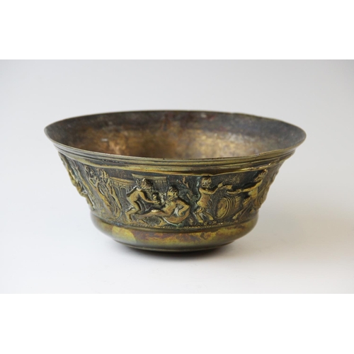 494 - A brass bowl 19th century, the flared rim cast with a continuous frieze of frolicking bacchanalian f... 