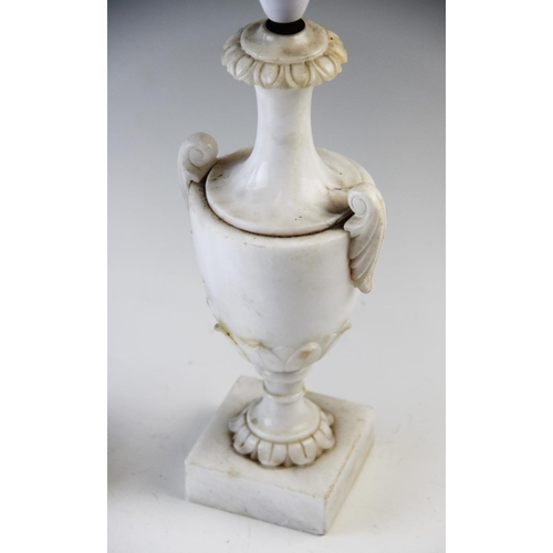 534 - A pair of alabaster lamp bases, each of classical two handled urn form, raised on square plinth base... 