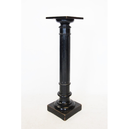 743 - A Victorian ebonised pedestal, the square top raised upon a fluted cylindrical column and square pli... 