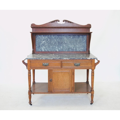 754 - An Edwardian two piece oak bedroom suite comprising; a marble top washstand with a swan neck pedimen... 