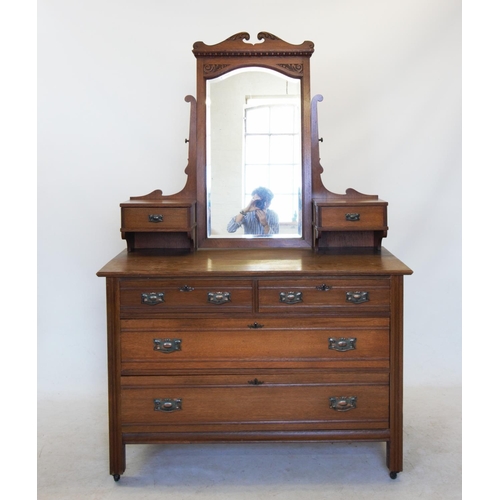 754 - An Edwardian two piece oak bedroom suite comprising; a marble top washstand with a swan neck pedimen... 