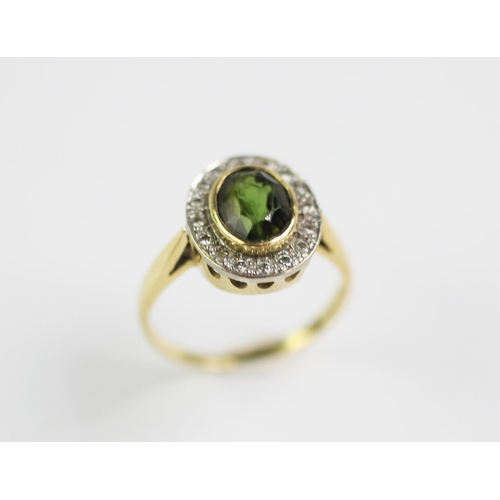 193 - A peridot and diamond cluster ring, designed as a central oval peridot, collet set in yellow gold, w... 