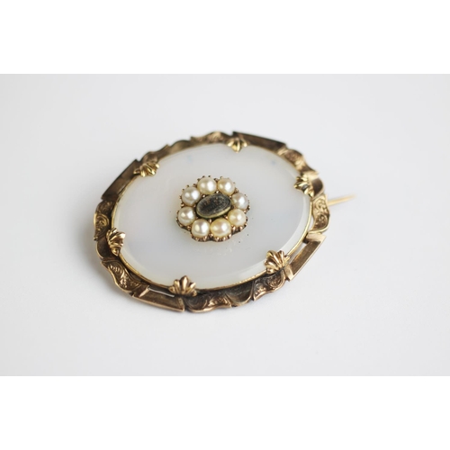 229 - A mourning brooch, 19th century, the oval brooch with central locket within split pearl set surround... 