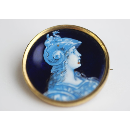 230 - An enamel on copper Limoges style brooch depicting a female classical warrior, of circular form and ... 