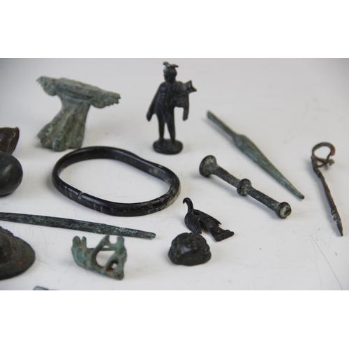 251 - A collection of Roman Empire and later artefacts, to include a Roman white metal pendant, 4cm long, ... 