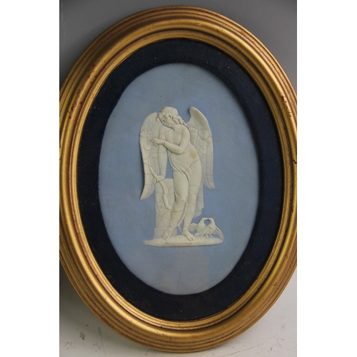 496 - A pair of Wedgwood blue jasper cameo ware oval plaques, depicting Cupid and a further classical figu... 