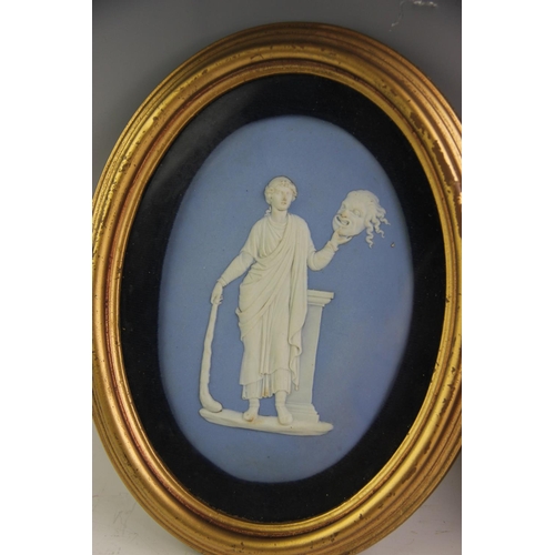 496 - A pair of Wedgwood blue jasper cameo ware oval plaques, depicting Cupid and a further classical figu... 