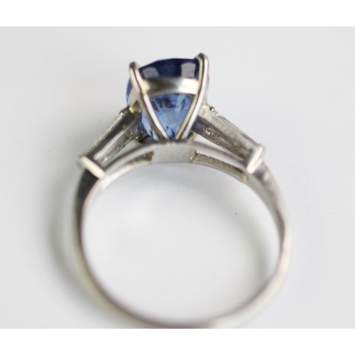 235 - A sapphire and diamond ring, the central rectangular, cushion mixed cut sapphire within a four claw ... 