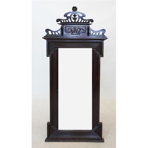 718 - A late 19th early 20th century stained hardwood wall mirror, with an open work crown shaped pediment... 