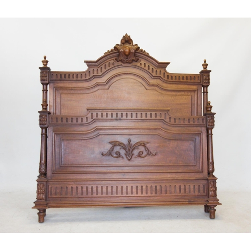 726 - A French Louis XV style walnut bed, late 19th century, the arched headboard with a carved scrolling ... 