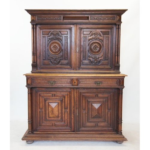 735 - A late 19th century French oak cupboard, with a moulded  and stepped cornice above a pair of cupboar... 