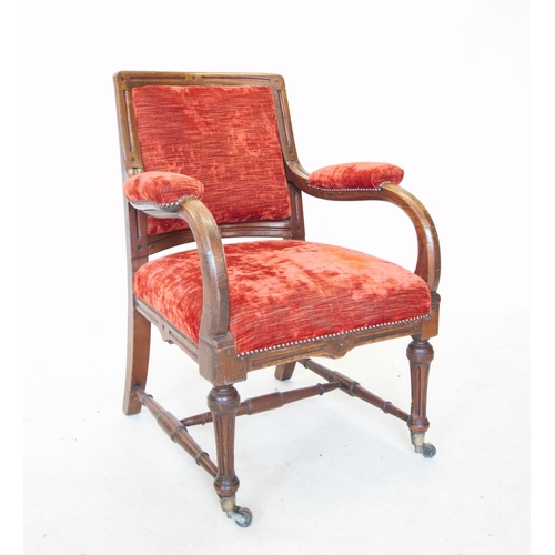 738 - A Victorian oak and upholstered library chair, the padded back within a fluted frame, above down swe... 