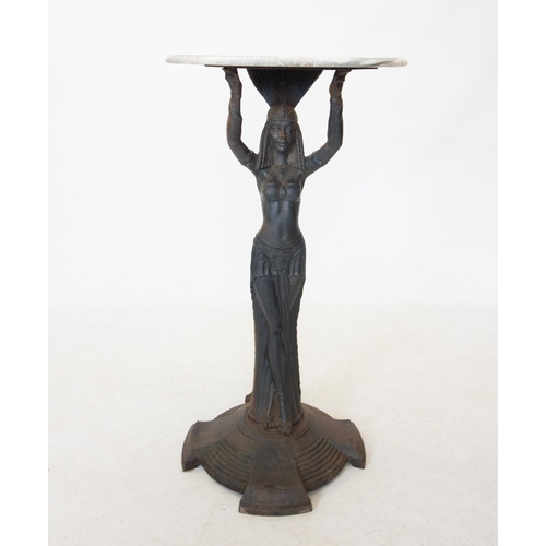 762 - An Art Deco cast iron figural bar table, the later white marble circular top raised upon an iron ped... 