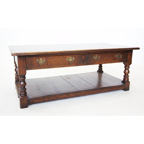 772 - A reproduction oak coffee table, 20th century, the rectangular top above two frieze drawers, raised ... 