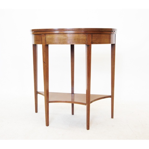 761 - An Edwardian mahogany demi lune folding card table, the satinwood cross banded top inlaid with fan d... 