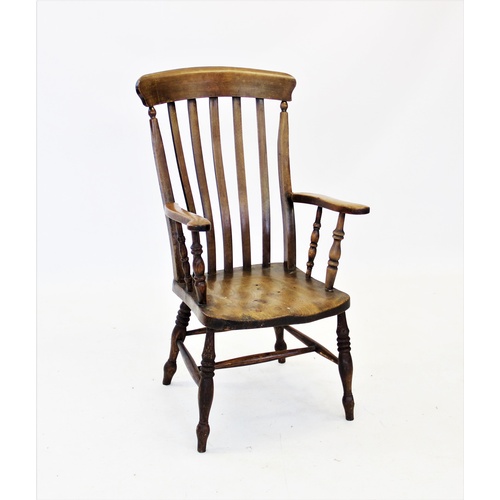 720 - A Victorian elm and beech wood farmhouse elbow chair, with a lath back above a shaped elm seat, rais... 