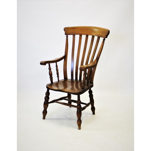 721 - A Victorian elm and beech wood Windsor farmhouse elbow chair, with a lath back above shaped seat, ra... 