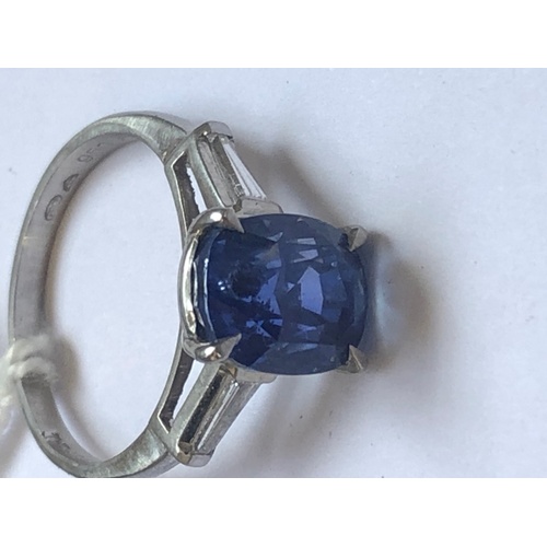 235 - A sapphire and diamond ring, the central rectangular, cushion mixed cut sapphire within a four claw ... 