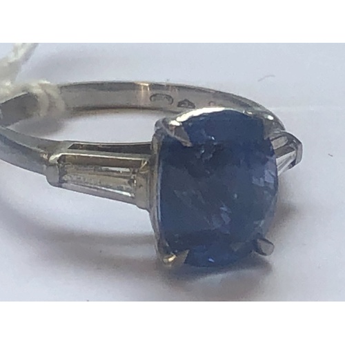 235 - A sapphire and diamond ring, the central rectangular, cushion mixed cut sapphire within a four claw ... 