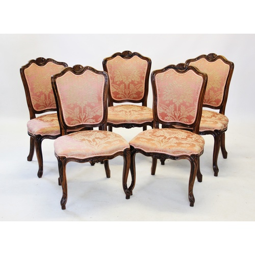 708A - A set of eight Louis XV style walnut framed dining chairs, each with a shell carved crest above a sh... 