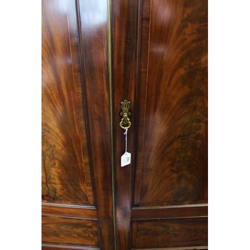 733 - A 19th century mahogany two door wardrobe, with a moulded cornice above a plain frieze and a pair of... 