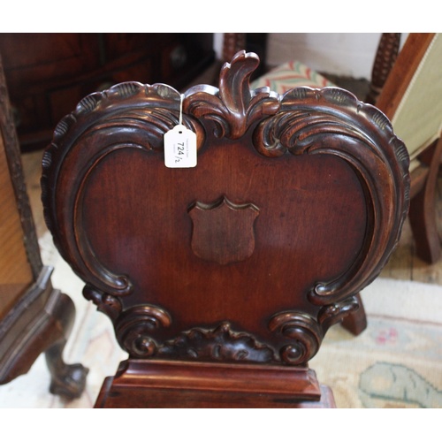 724 - A Victorian mahogany hall chair, the apple shaped back applied with 'C' scroll carving and centred w... 