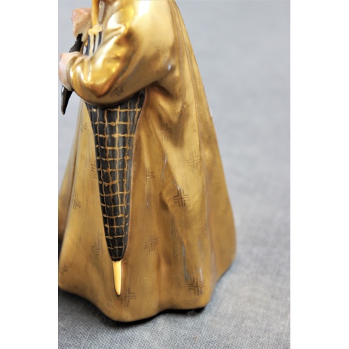 498 - A Royal Copenhagen figure 'The Sandman' model number 1145, with gilt coat and hat, 16cm high