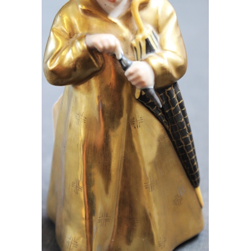 498 - A Royal Copenhagen figure 'The Sandman' model number 1145, with gilt coat and hat, 16cm high