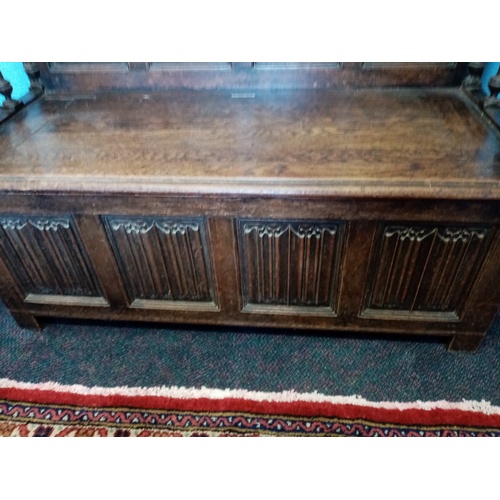 713 - A late Victorian carved oak box settle, in the 17th century style, the high back with four panels ea... 