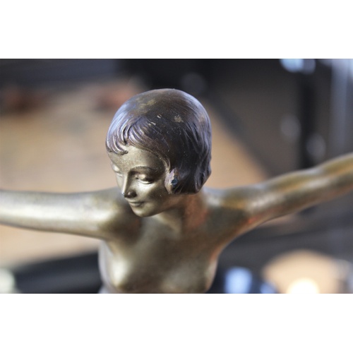 388 - An Art Deco spelter figure, early 20th century, the gilt patinated figure modelled as a girl dancing... 