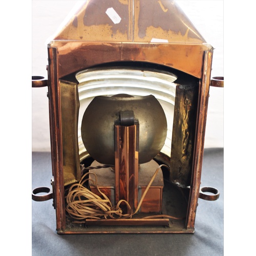 538 - A late 19th/early 20th century ships copper masthead lantern, with a brass swing handle above a bras... 