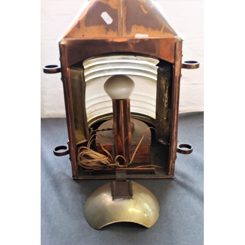 538 - A late 19th/early 20th century ships copper masthead lantern, with a brass swing handle above a bras... 