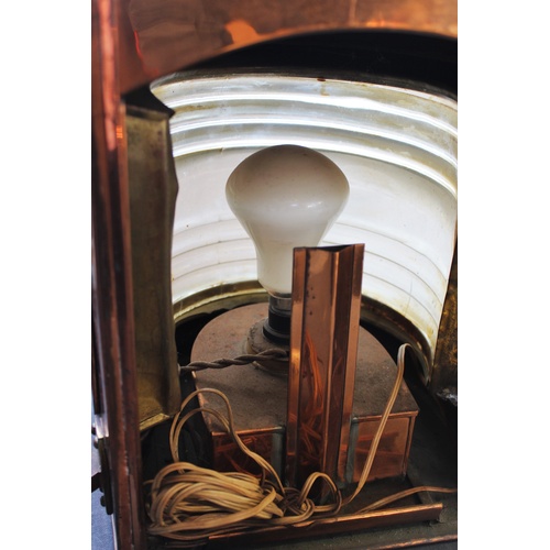 538 - A late 19th/early 20th century ships copper masthead lantern, with a brass swing handle above a bras... 