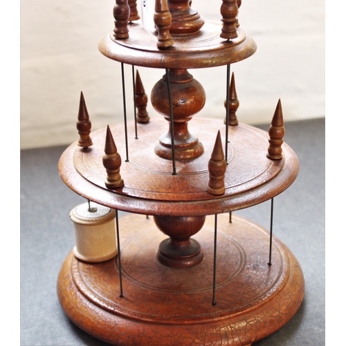 399 - A Victorian treen cotton reel holder, with two graduated tiers, each with six wire holders applied w... 