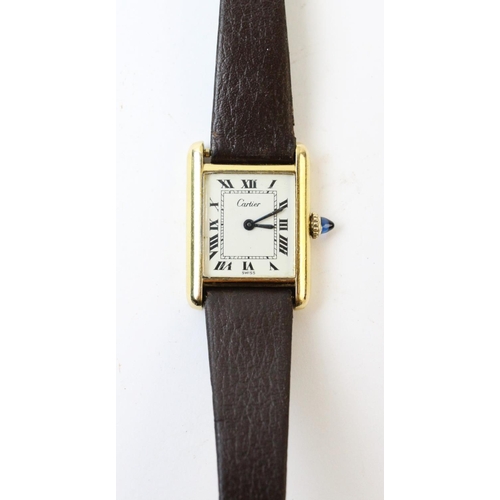 109 - A lady's gold plated Cartier Tank wristwatch, the rectangular cream dial with black Roman numerals, ... 