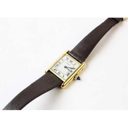 109 - A lady's gold plated Cartier Tank wristwatch, the rectangular cream dial with black Roman numerals, ... 