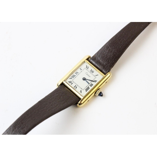 109 - A lady's gold plated Cartier Tank wristwatch, the rectangular cream dial with black Roman numerals, ... 