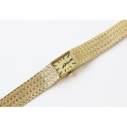 119 - A lady's vintage 9ct gold Omega wristwatch, comprising a rectangular gold toned dial with baton mark... 