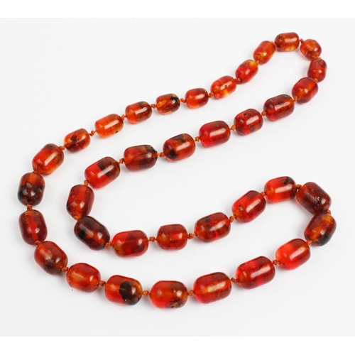 121 - An amber bead necklace, designed as a single strand of thirty seven beads, gross weight 73.3gms