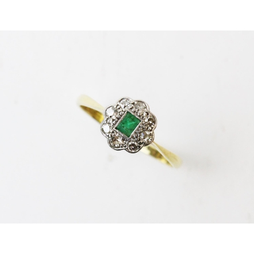 126 - An early 20th century emerald and diamond ring, comprising a central rectangular step cut emerald wi... 