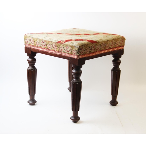 665 - A mid-19th century mahogany foot stool, the square needlepoint top supported by four tapered carved ... 