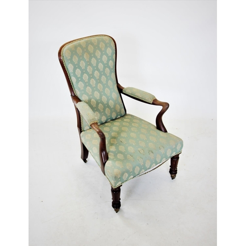 672 - A William IV mahogany framed open armchair, the padded spoon back with a mahogany frame extending to... 