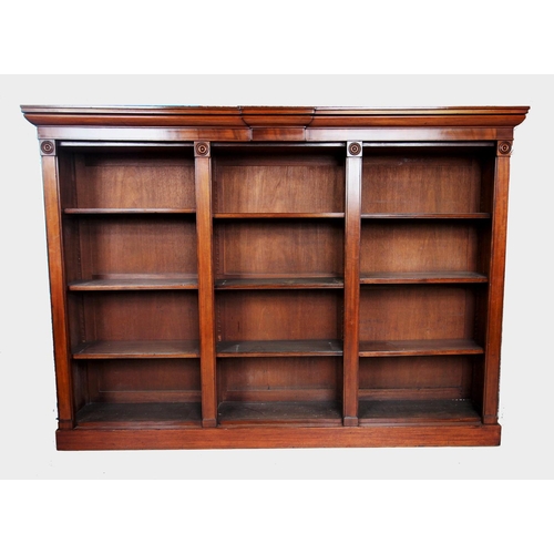 681 - A mid 19th century mahogany open bookcase, the rectangular top with a small break front above an arr... 