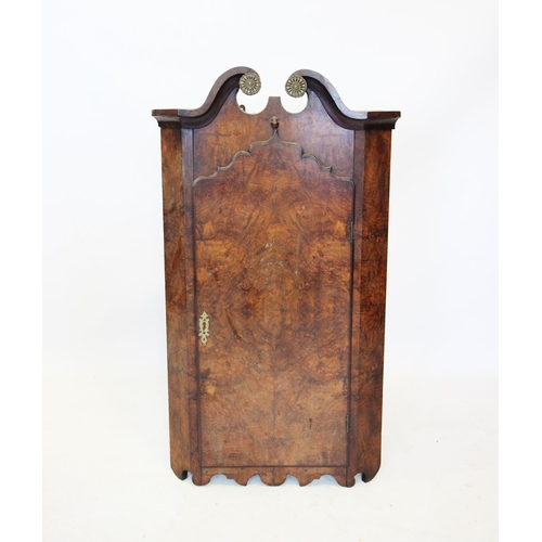 688 - A Queen Anne style burr walnut hanging corner cupboard, 19th century, with a twin swan neck pediment... 