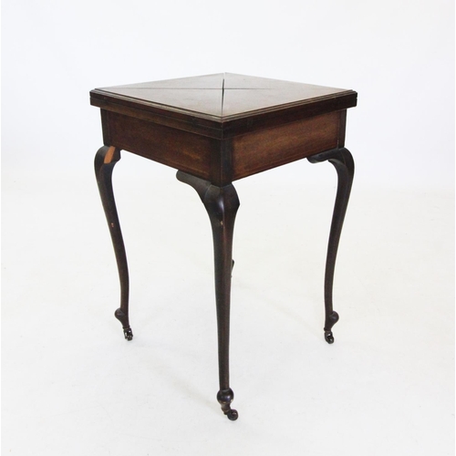 701 - An Edwardian mahogany envelope games table, the folding top enclosing a baize lined surface, raised ... 