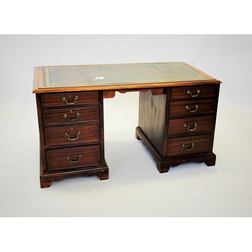 703 - An early 20th century mahogany twin pedestal desk, the rectangular moulded top with a gilt tooled gr... 