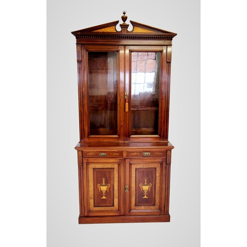 704 - An Edwardian Sheraton revival mahogany library bookcase, the architectural pediment inlaid with sati... 