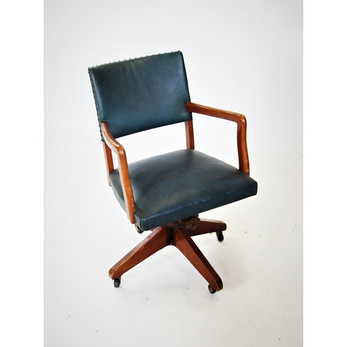 715 - A mid 20th century revolving office desk chair, with padded back and sprung seat enclosed by stained... 