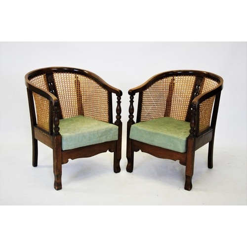 722 - A pair of early 20th century stained beech wood rattan tub chairs, the horse shoe shaped top rail, a... 